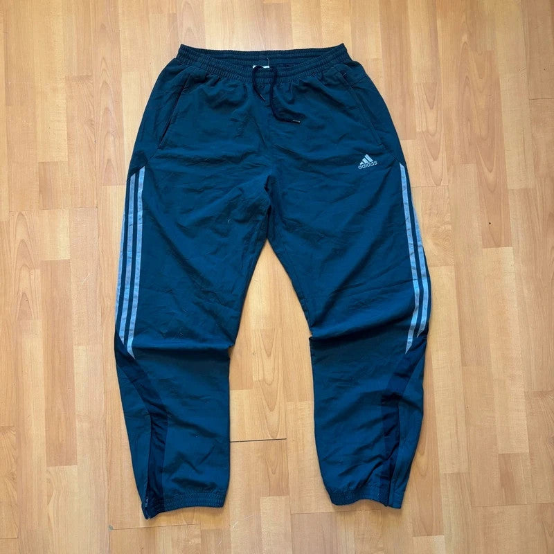 Adidas grey joggers with reflective three-stripe detailing and adjustable drawstring waist.