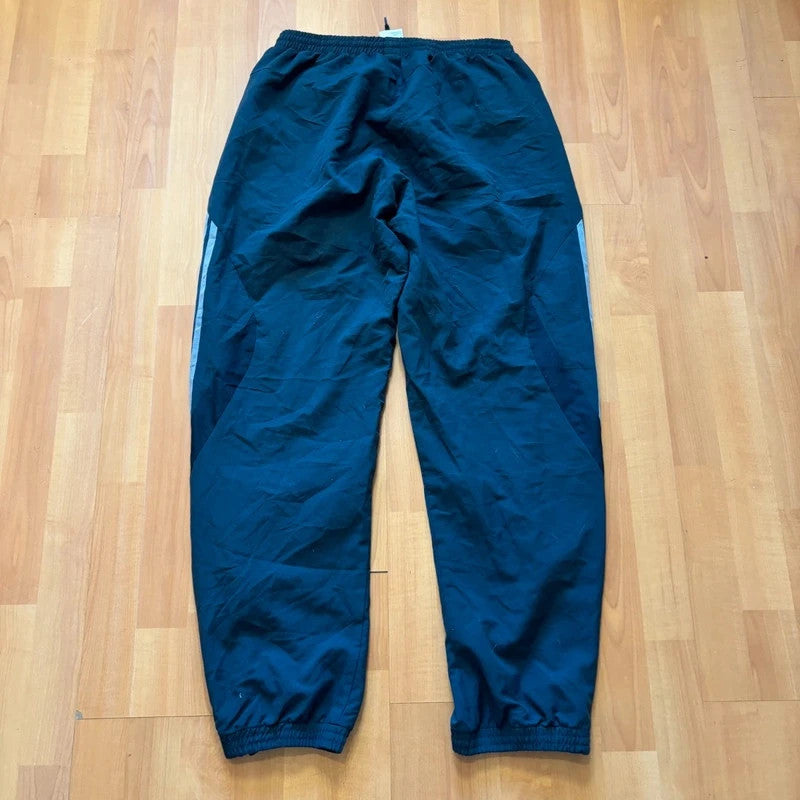 Adidas grey joggers with reflective three-stripe detailing and adjustable drawstring waist.
