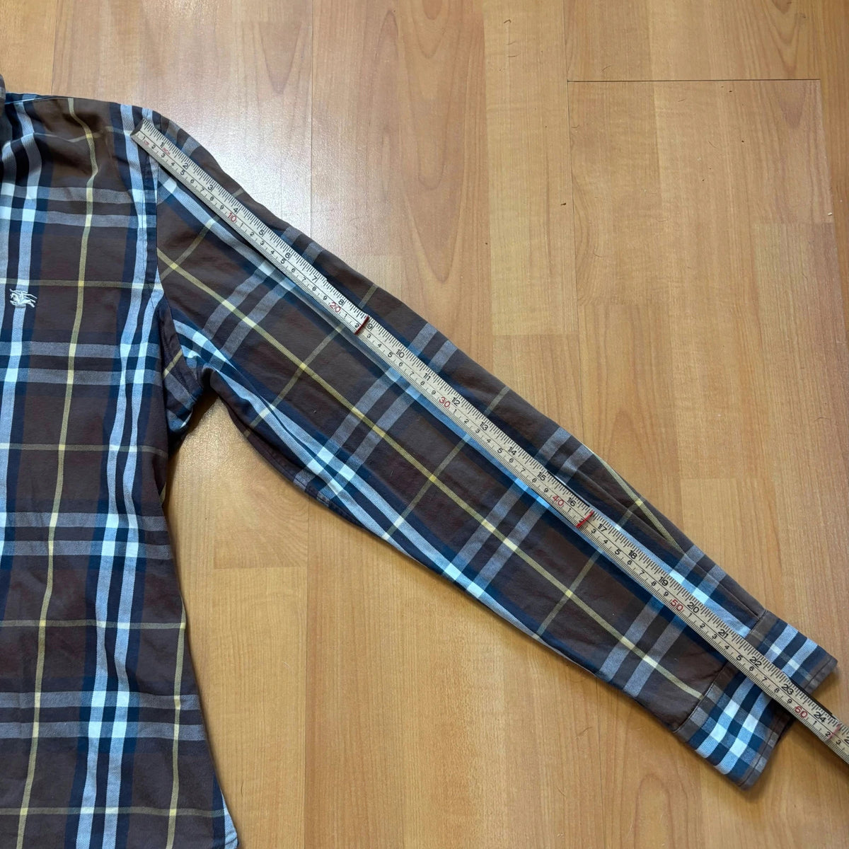 Burberry men's button-up shirt blue and brown plaid with knight logo embroidered on chest.