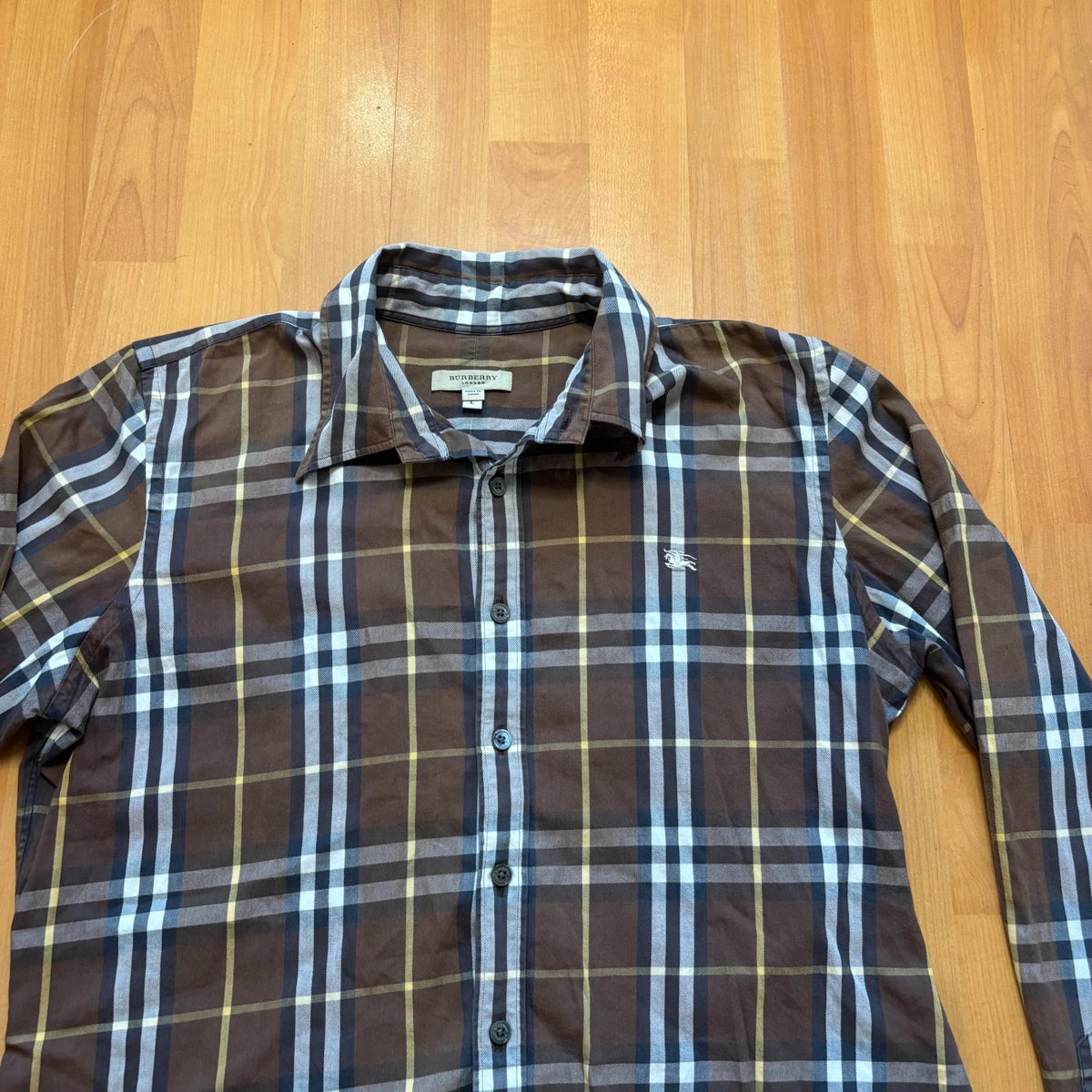 Burberry men's button-up shirt blue and brown plaid with knight logo embroidered on chest.