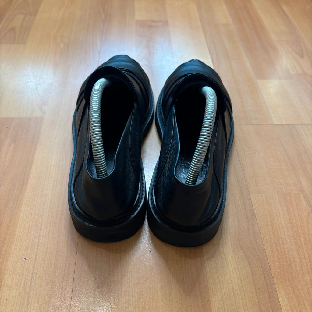 Rotten Closet black leather Morph Mules with collapsible heel and rugged vibram soles.