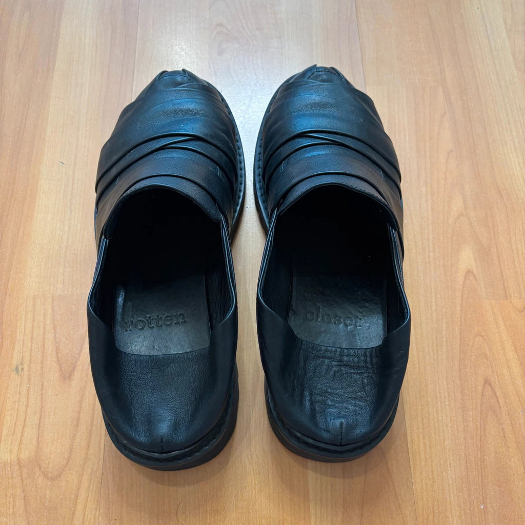 Rotten Closet black leather Morph Mules with collapsible heel and rugged vibram soles.