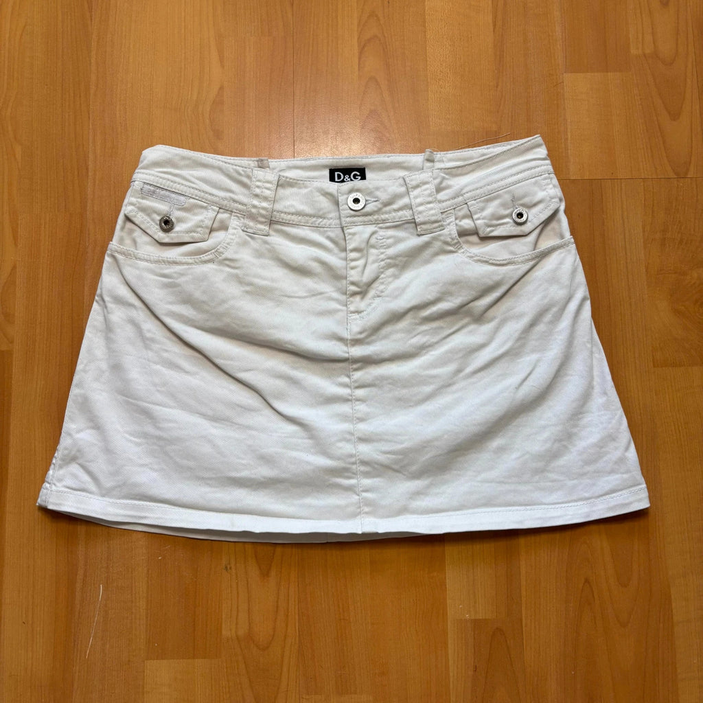 Dolce & Gabbana white denim mini skirt with utility pockets and branded hardware.