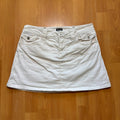 Dolce & Gabbana white denim mini skirt with utility pockets and branded hardware.