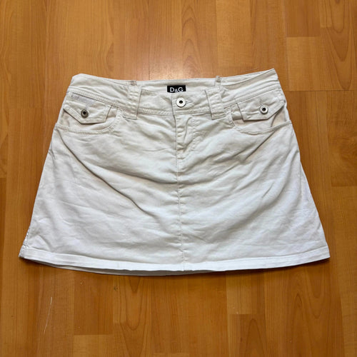 Dolce & Gabbana white denim mini skirt with utility pockets and branded hardware.