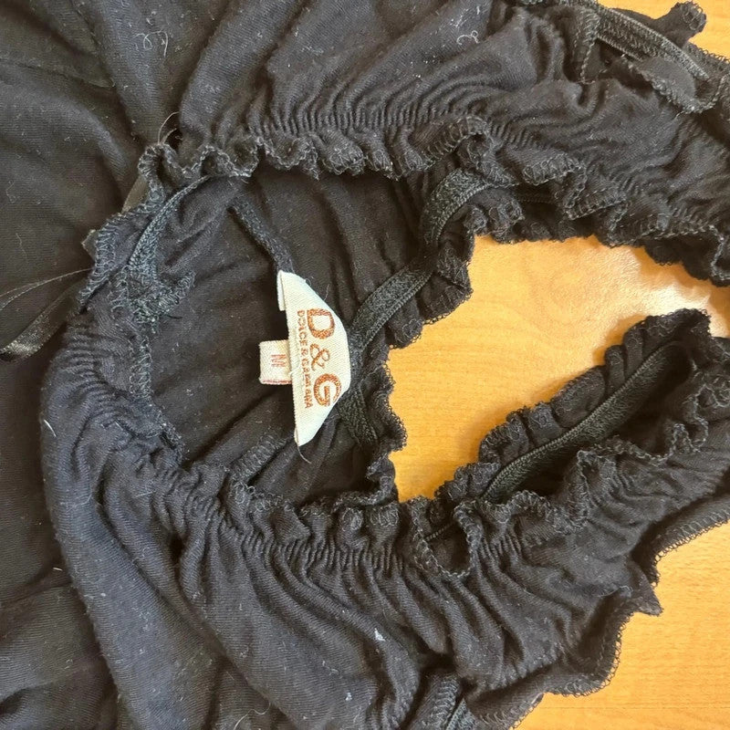 Dolce & Gabbana black cami tank top with ruffled neckline and rhinestone logo detail.