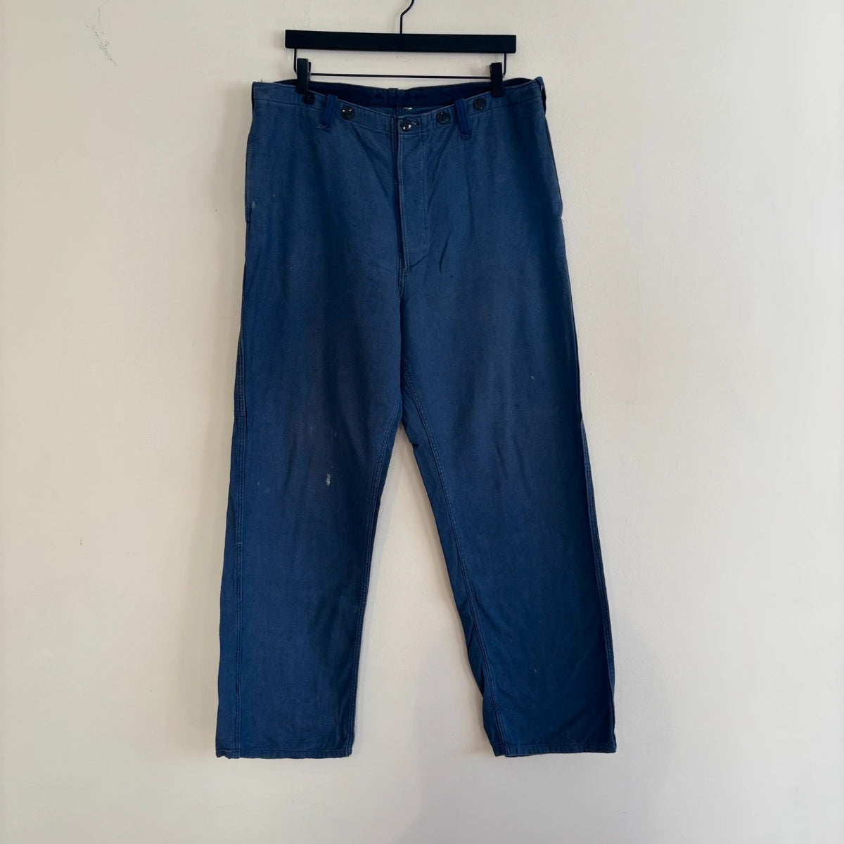Reclaimed Vintage blue wide-leg trousers with button fly and side tool pocket accents.