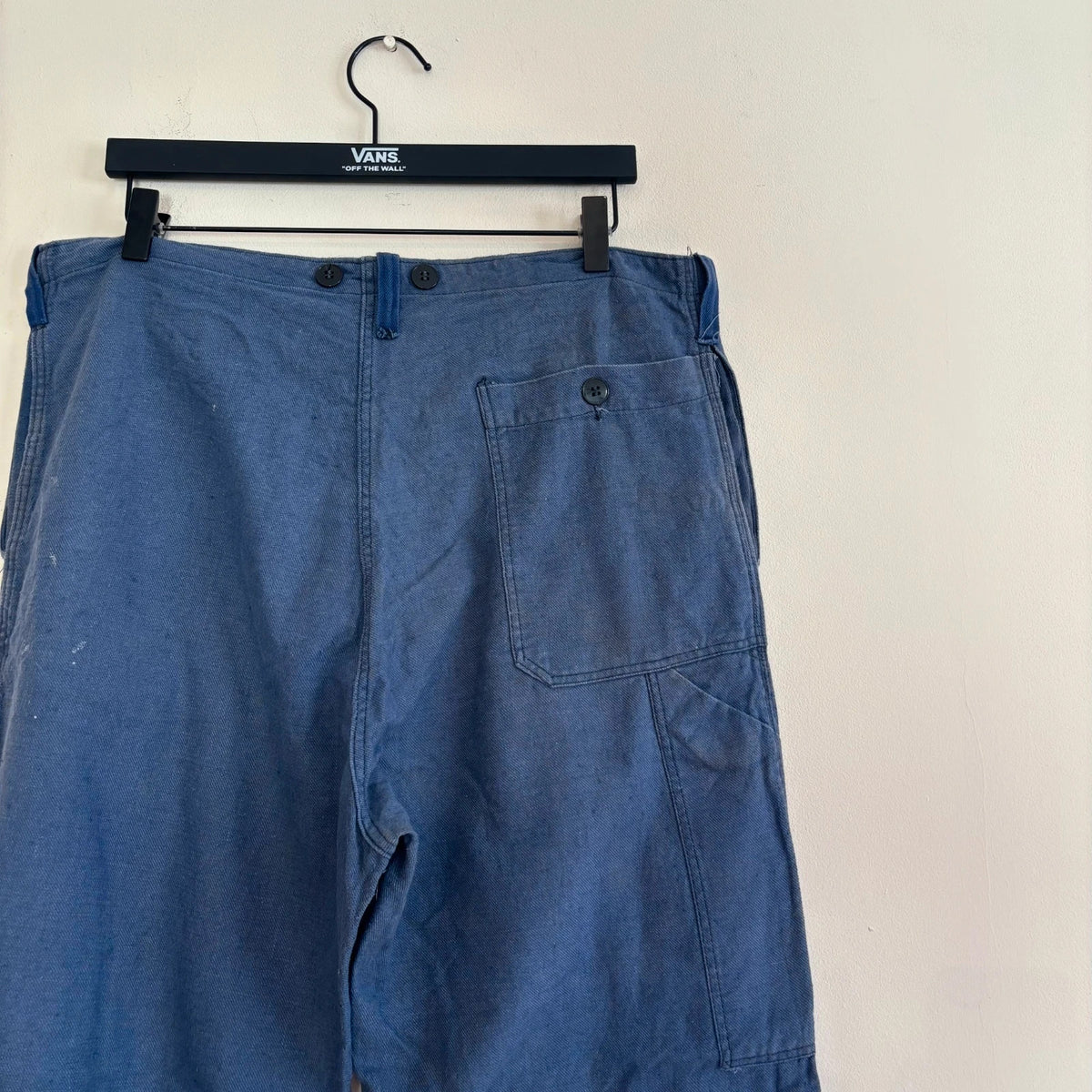 Reclaimed Vintage blue wide-leg trousers with button fly and side tool pocket accents.