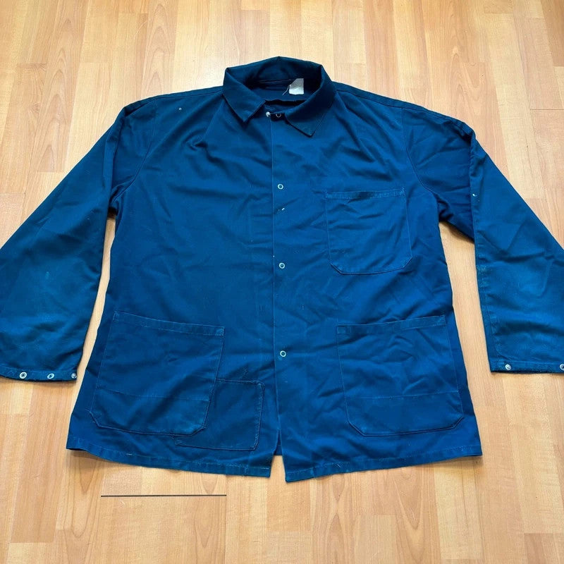Vintage Dressing navy chore jacket with snap buttons, utility pockets, and patch repair detail.