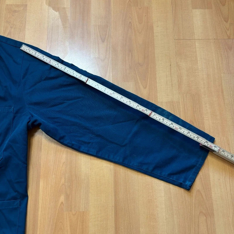 Vintage Dressing navy chore jacket with snap buttons, utility pockets, and patch repair detail.