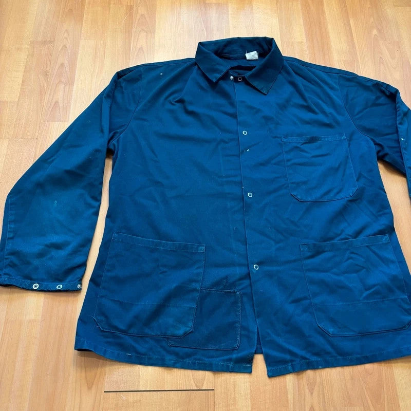 Vintage Dressing navy chore jacket with snap buttons, utility pockets, and patch repair detail.