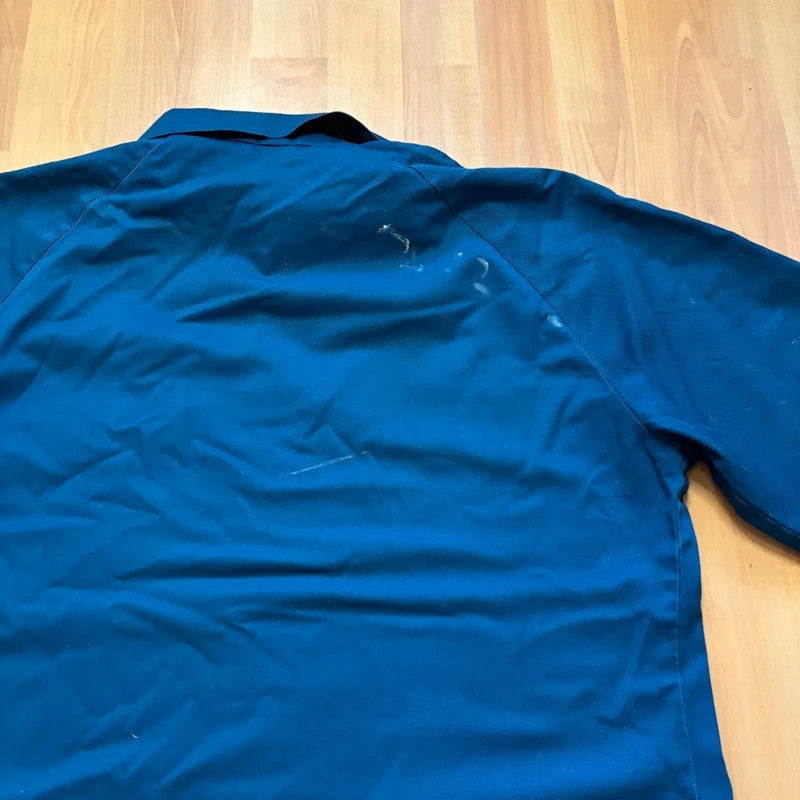 Vintage Dressing navy chore jacket with snap buttons, utility pockets, and patch repair detail.