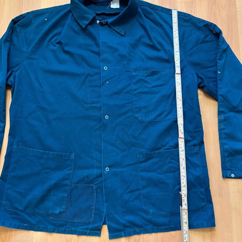 Vintage Dressing navy chore jacket with snap buttons, utility pockets, and patch repair detail.