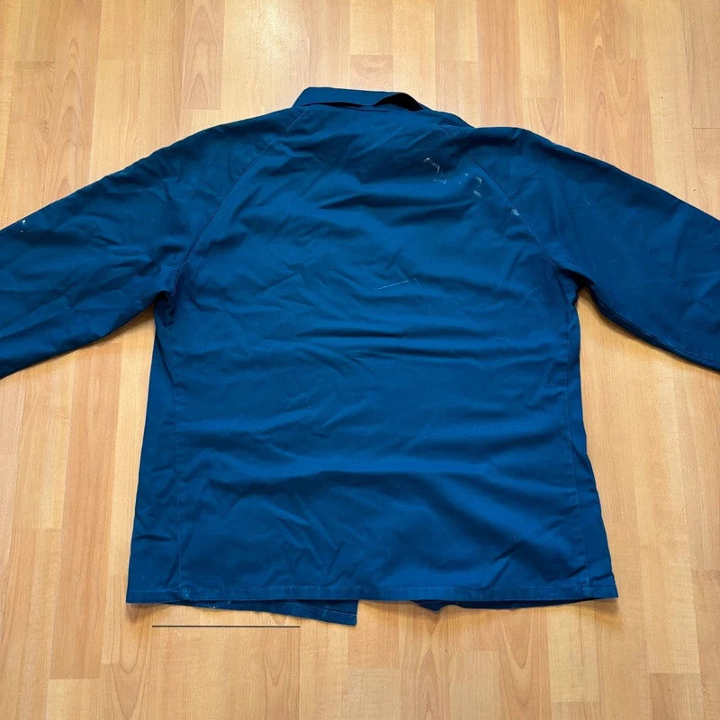 Vintage Dressing navy chore jacket with snap buttons, utility pockets, and patch repair detail.