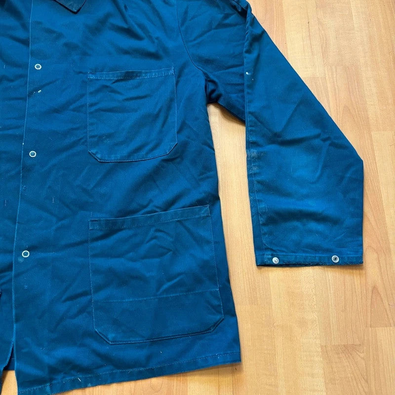 Vintage Dressing navy chore jacket with snap buttons, utility pockets, and patch repair detail.