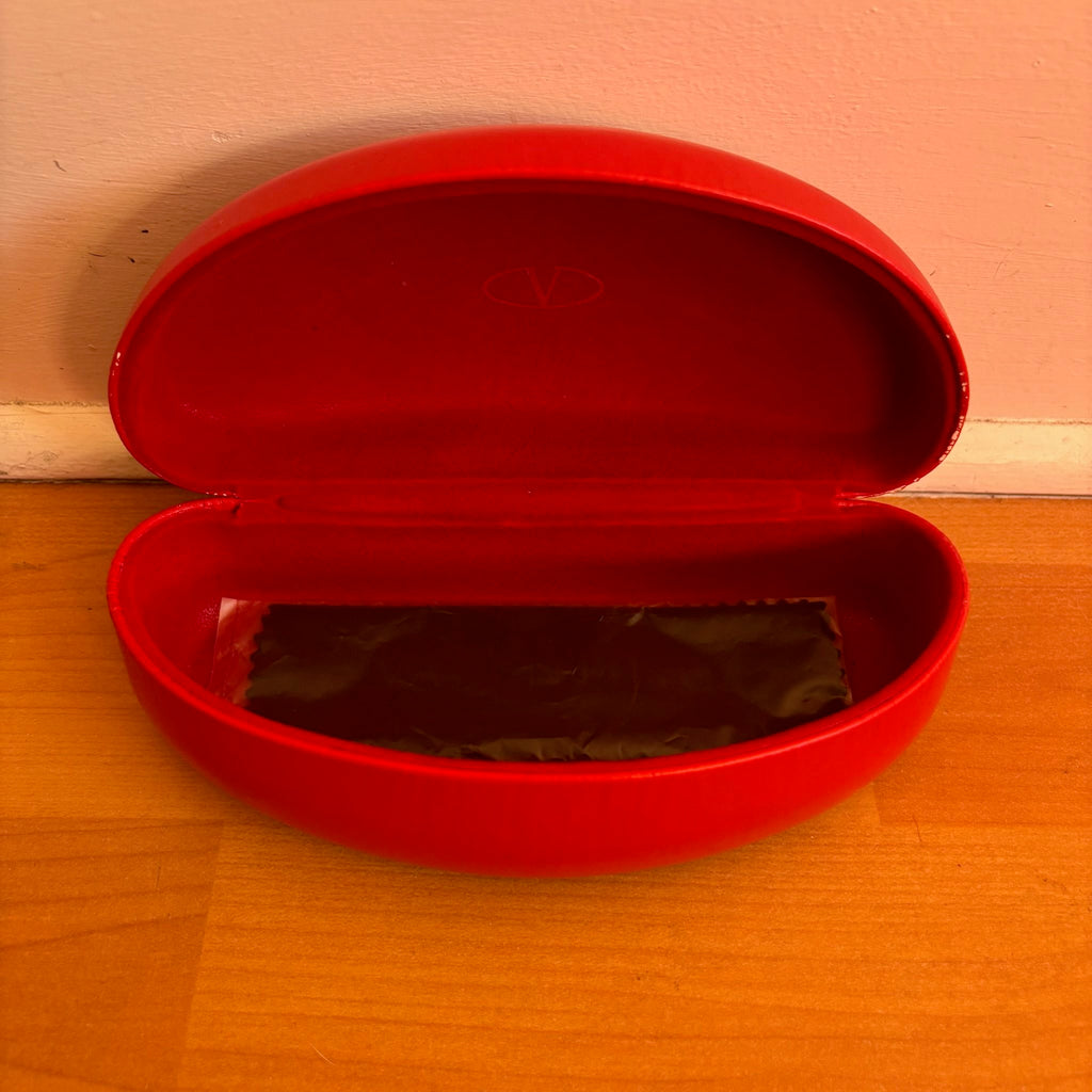 Valentino black sunglasses with rhinestone detailing and red hard case featuring logo.