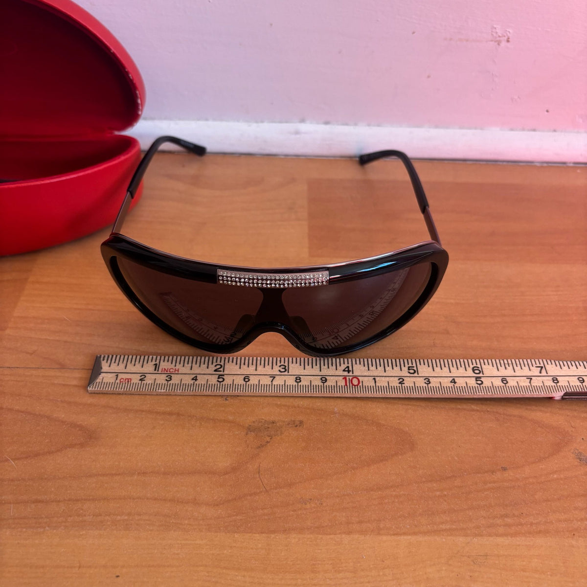 Valentino black sunglasses with rhinestone detailing and red hard case featuring logo.