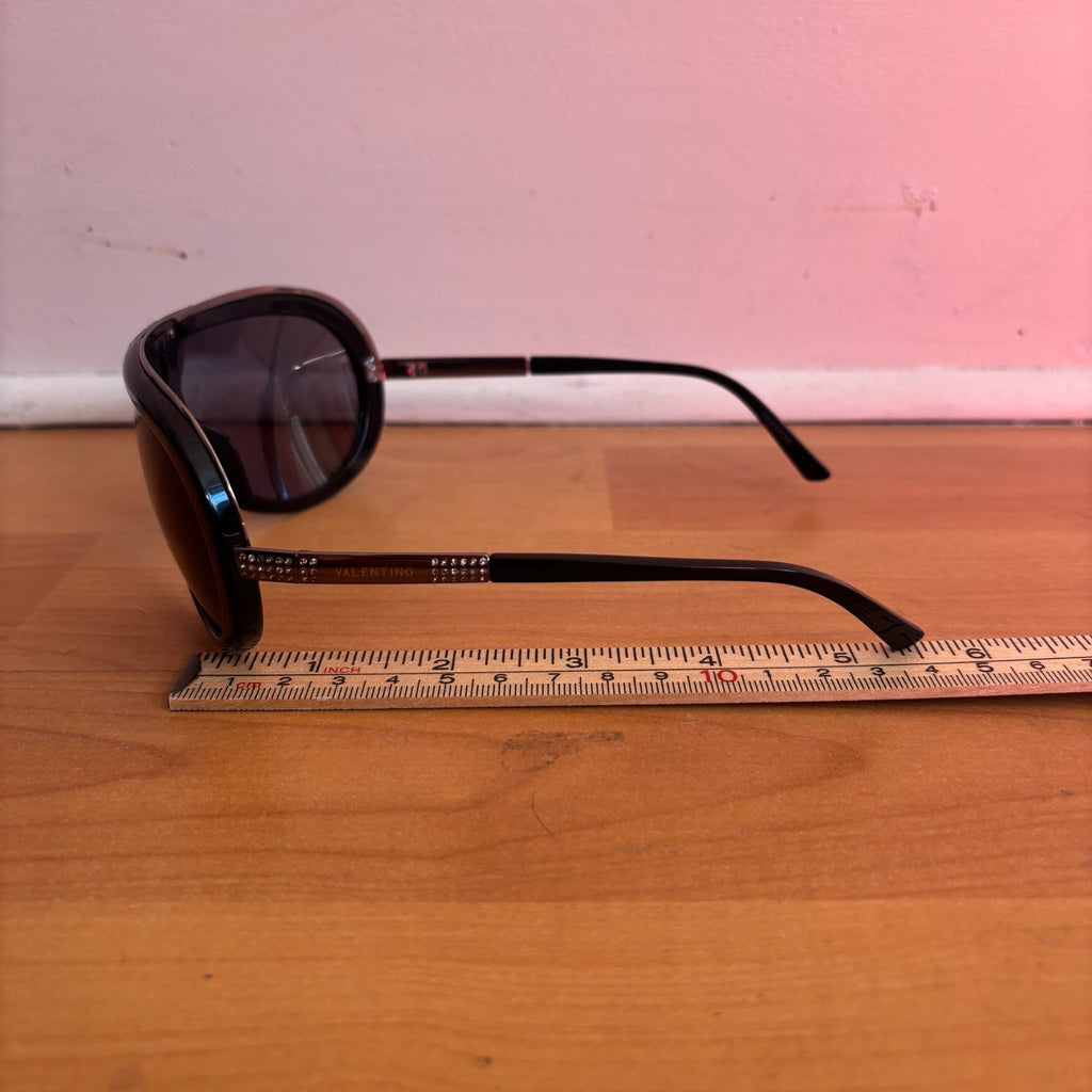 Valentino black sunglasses with rhinestone detailing and red hard case featuring logo.