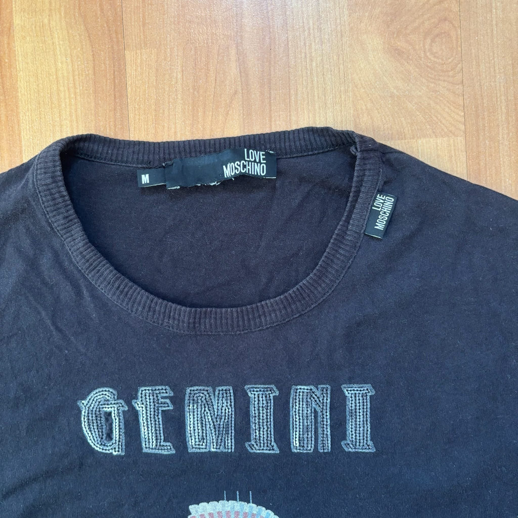 Love Moschino black long sleeve t-shirt with Gemini graphic, ribbed crew neckline, 100% cotton.