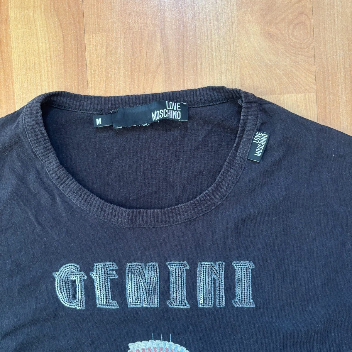 Love Moschino black long sleeve t-shirt with Gemini graphic, ribbed crew neckline, 100% cotton.
