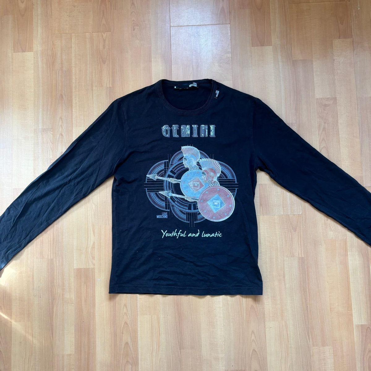 Love Moschino black long sleeve t-shirt with Gemini graphic, ribbed crew neckline, 100% cotton.