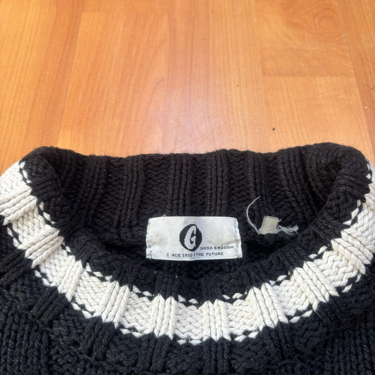GOOD ENOUGH black and white knitted fisherman sweater with ribbed texture and striped collar.