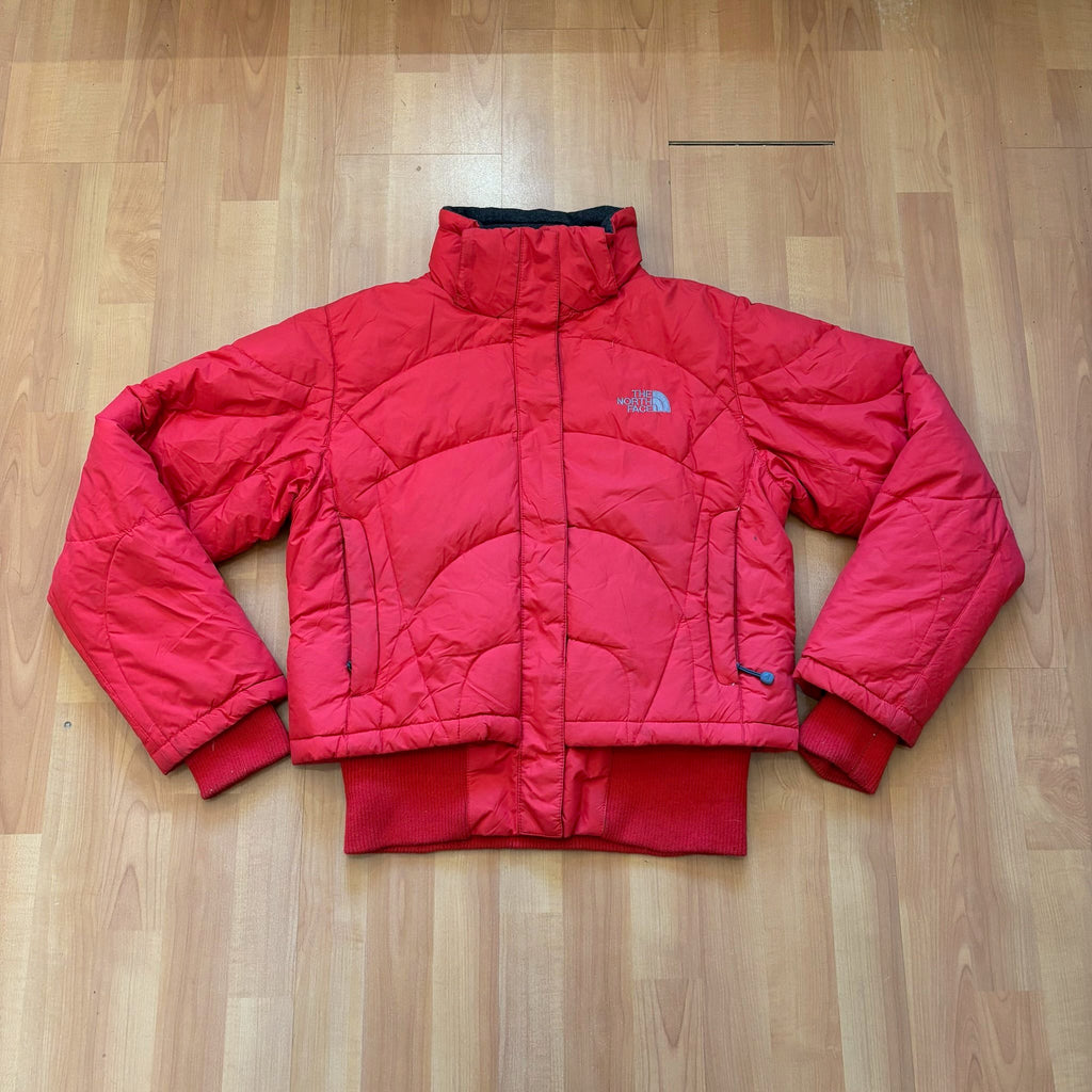 The North Face red down jacket with faux fur hood, ribbed cuffs, and zip pockets.