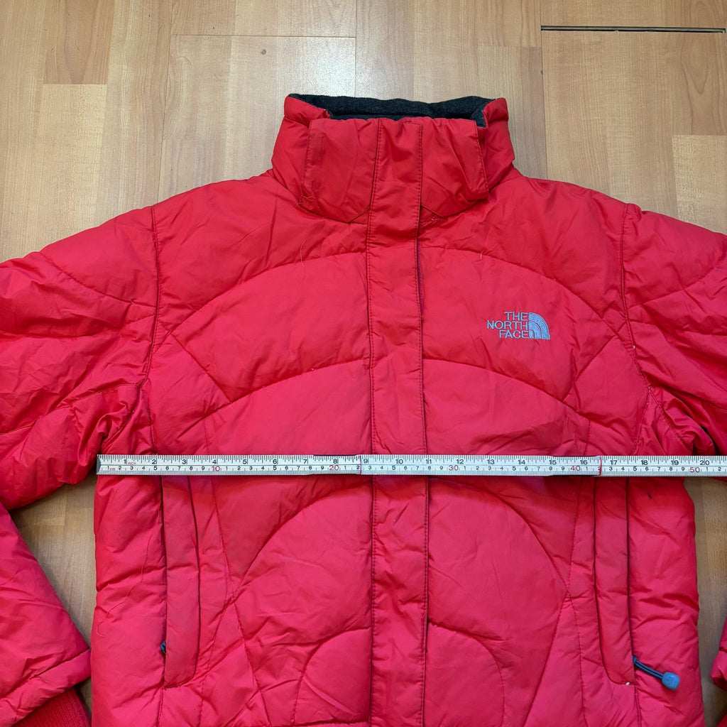 The North Face red down jacket with faux fur hood, ribbed cuffs, and zip pockets.