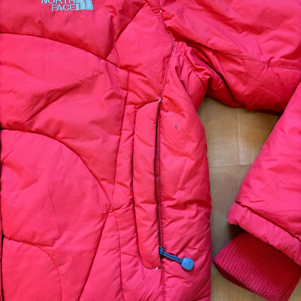 The North Face red down jacket with faux fur hood, ribbed cuffs, and zip pockets.