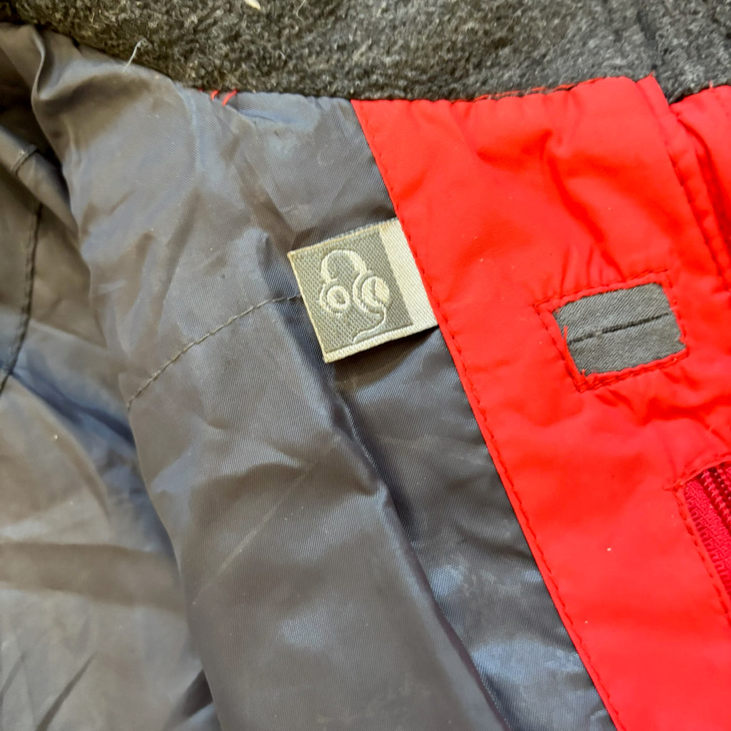 The North Face red down jacket with faux fur hood, ribbed cuffs, and zip pockets.
