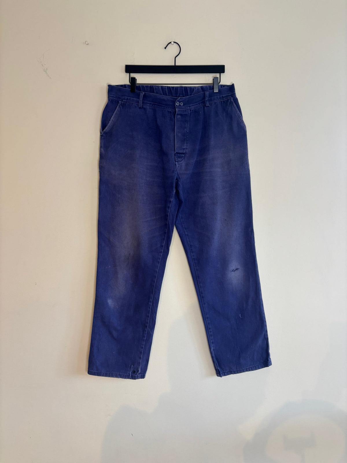 Workwear blue moleskin trousers with snap-button fly and utility pockets, vintage style.