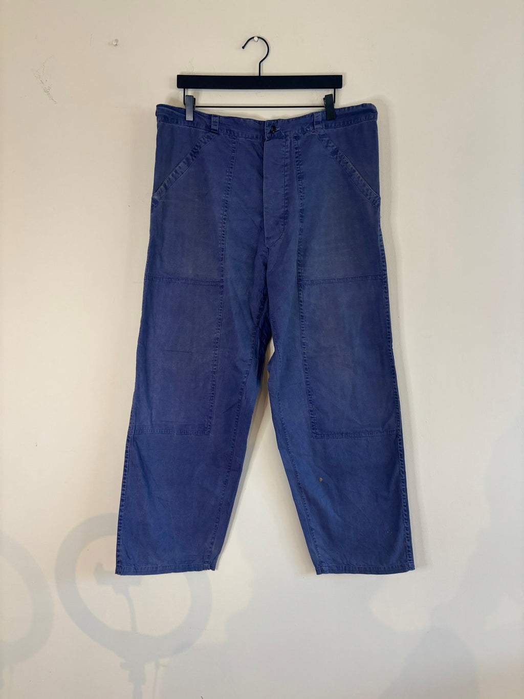 Vintage blue cotton twill pants with double-knee panels and adjustable back-buckle cinch.