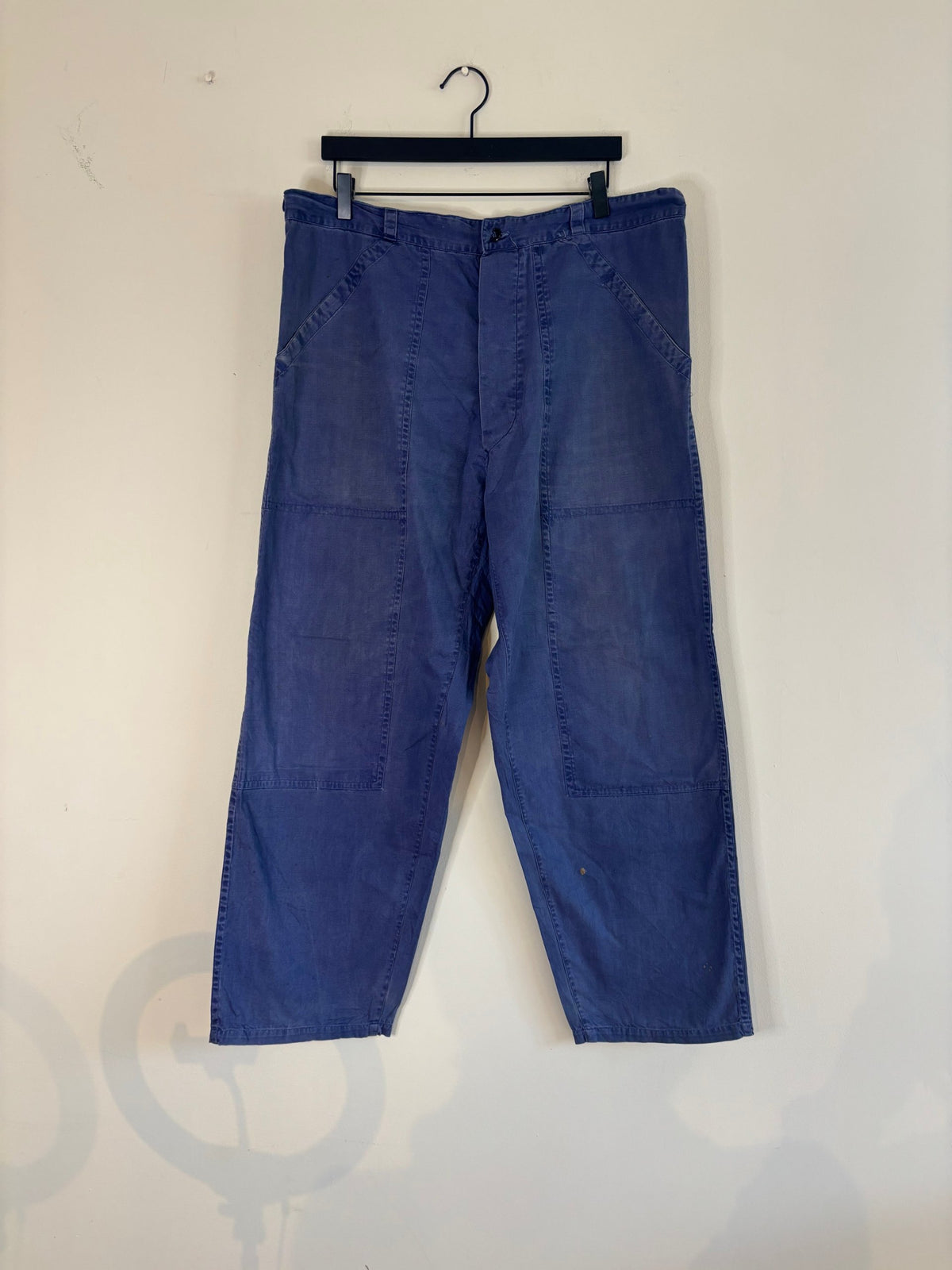 Vintage blue cotton twill pants with double-knee panels and adjustable back-buckle cinch.