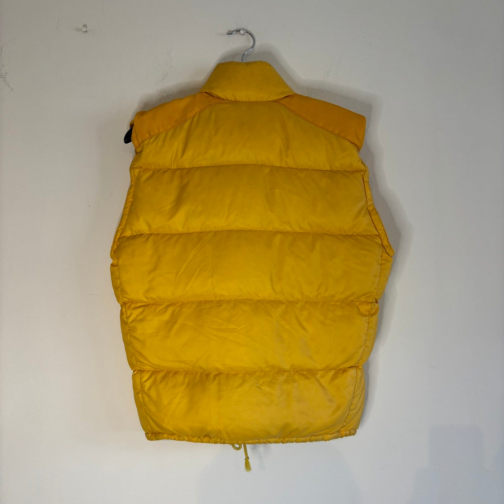 Moncler yellow down gilet vest with snap-button placket and zip pockets, made in France.