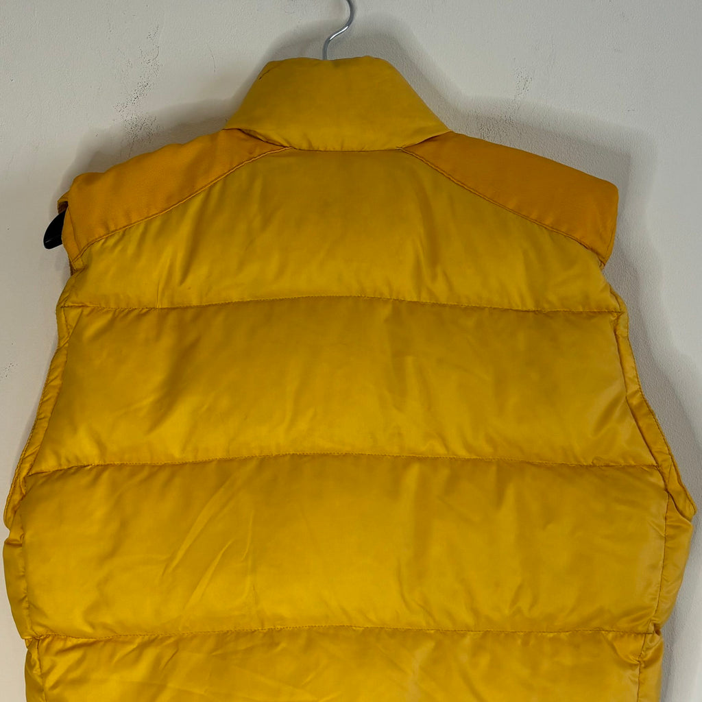 Moncler yellow down gilet vest with snap-button placket and zip pockets, made in France.