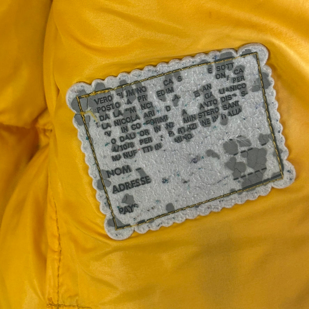 Moncler yellow down gilet vest with snap-button placket and zip pockets, made in France.
