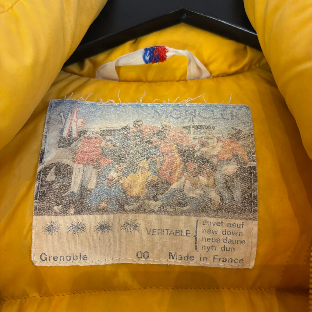 Moncler yellow down gilet vest with snap-button placket and zip pockets, made in France.