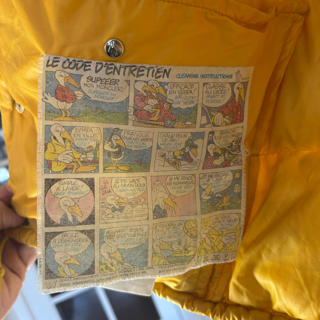 Moncler yellow down gilet vest with snap-button placket and zip pockets, made in France.