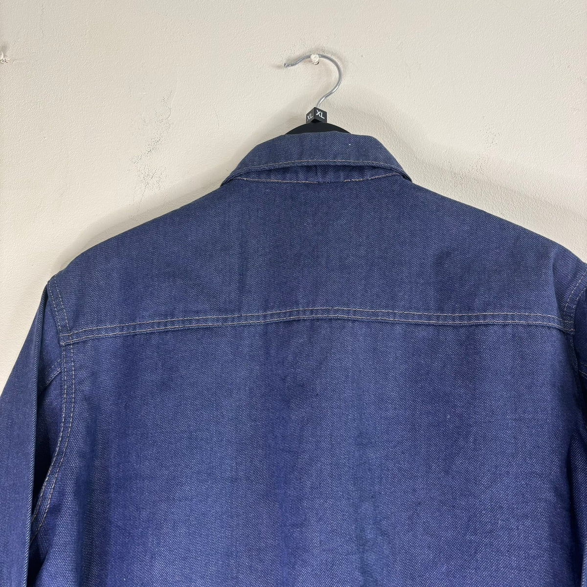 Vétra blue denim jacket with gold stitching, star-embossed buttons, and red logo tab.