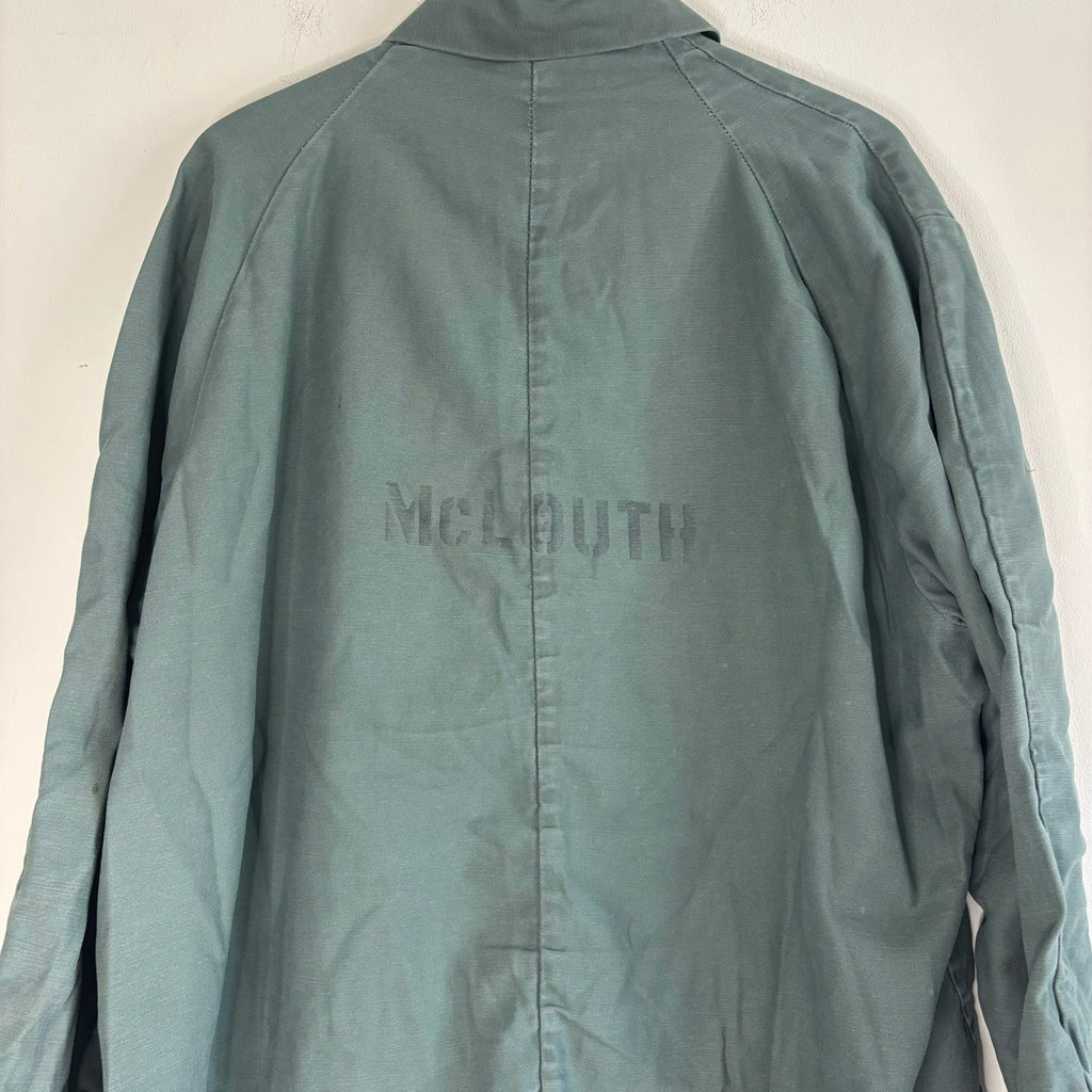 Vintage green cotton work jacket with snap front and stencilled "McLOUTH" on back.