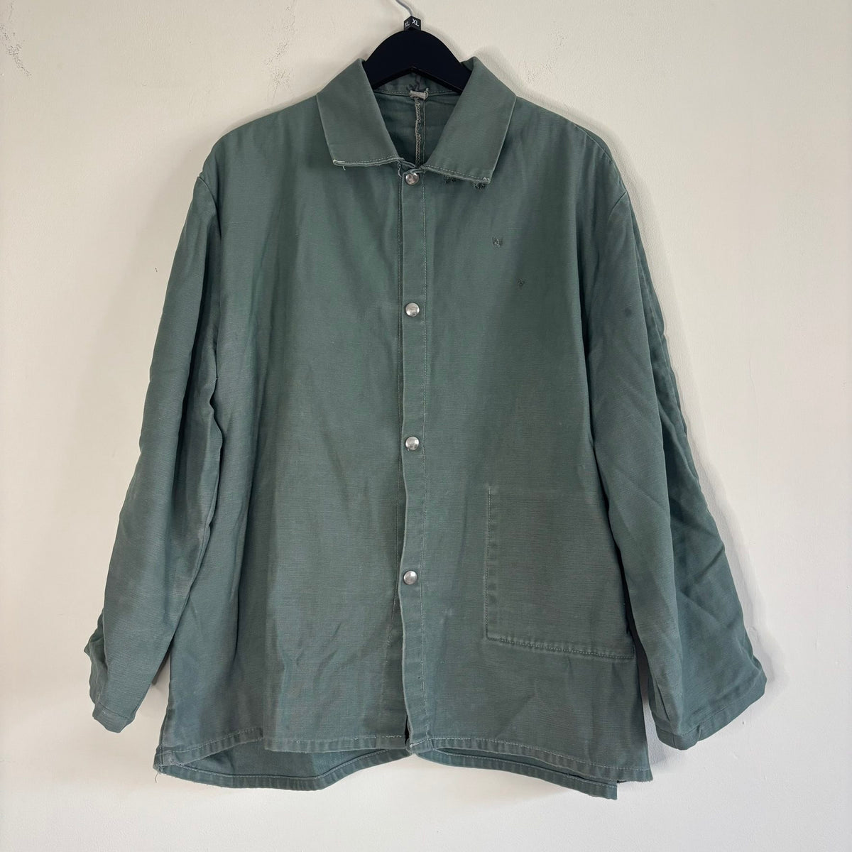 Vintage green cotton work jacket with snap front and stencilled "McLOUTH" on back.