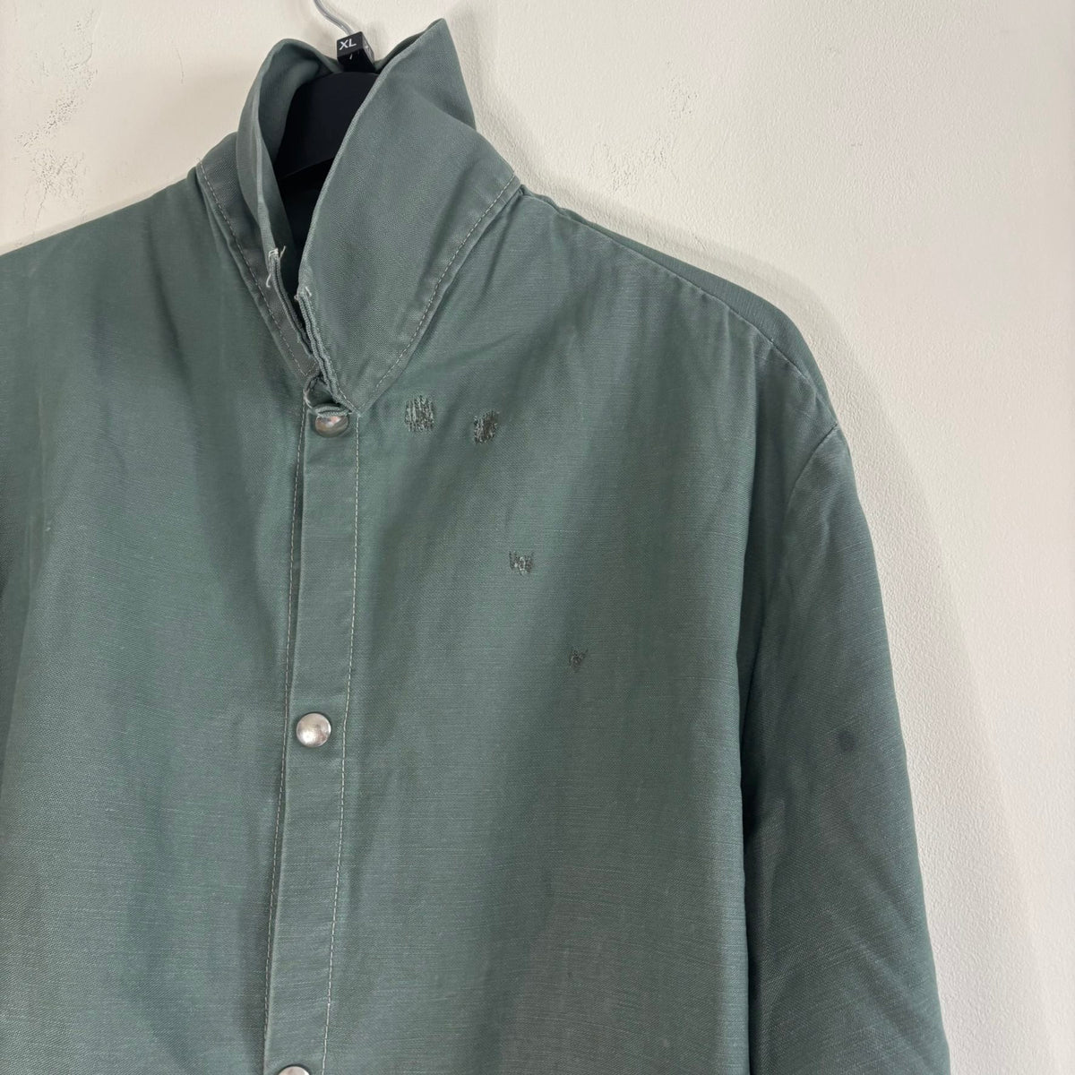 Vintage green cotton work jacket with snap front and stencilled "McLOUTH" on back.