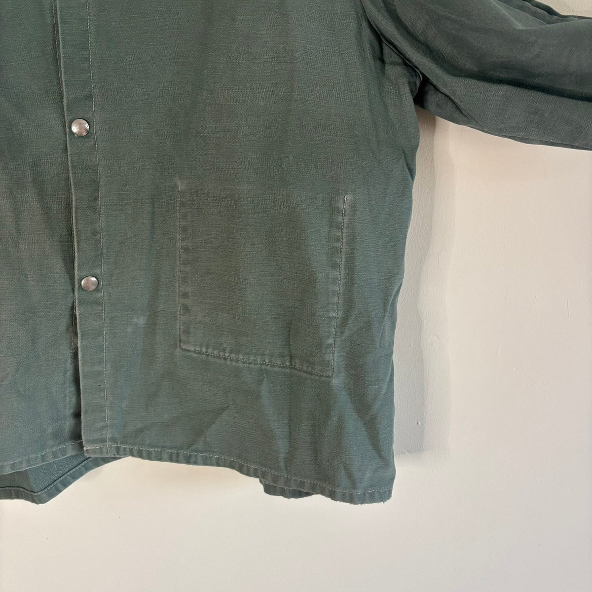 Vintage green cotton work jacket with snap front and stencilled "McLOUTH" on back.