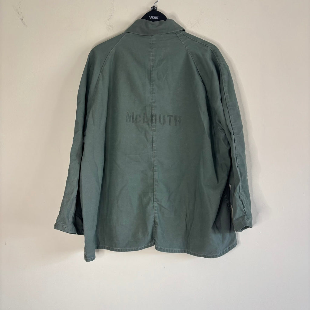 Vintage green cotton work jacket with snap front and stencilled "McLOUTH" on back.
