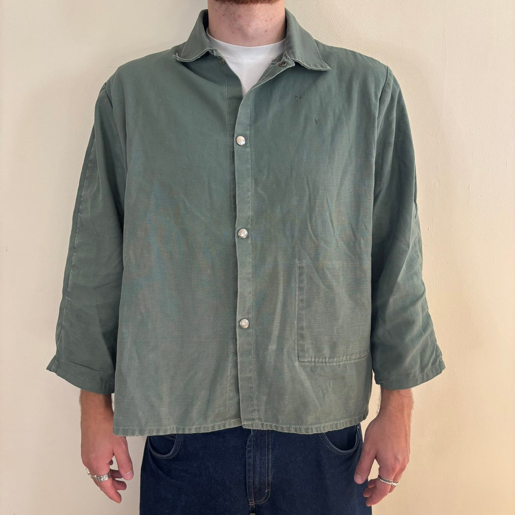 Vintage green cotton work jacket with snap front and stencilled "McLOUTH" on back.