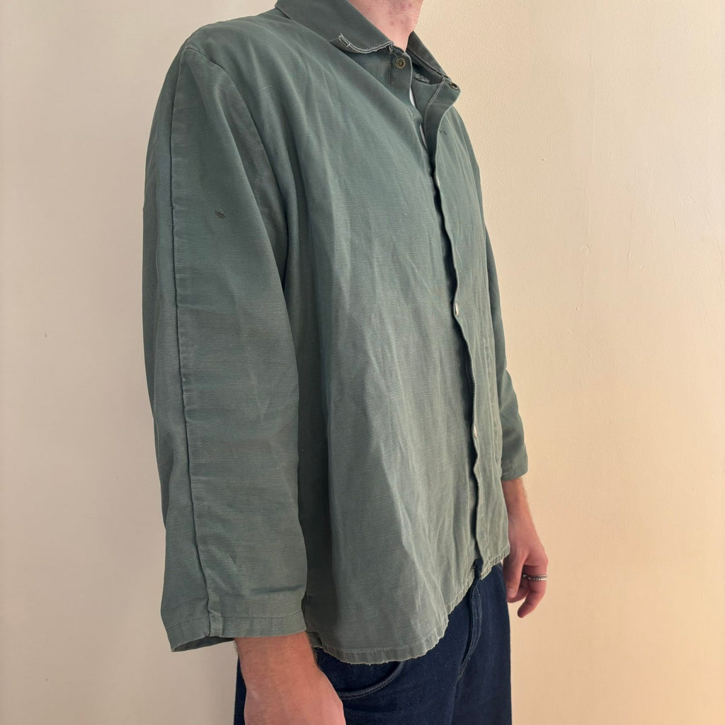Vintage green cotton work jacket with snap front and stencilled "McLOUTH" on back.