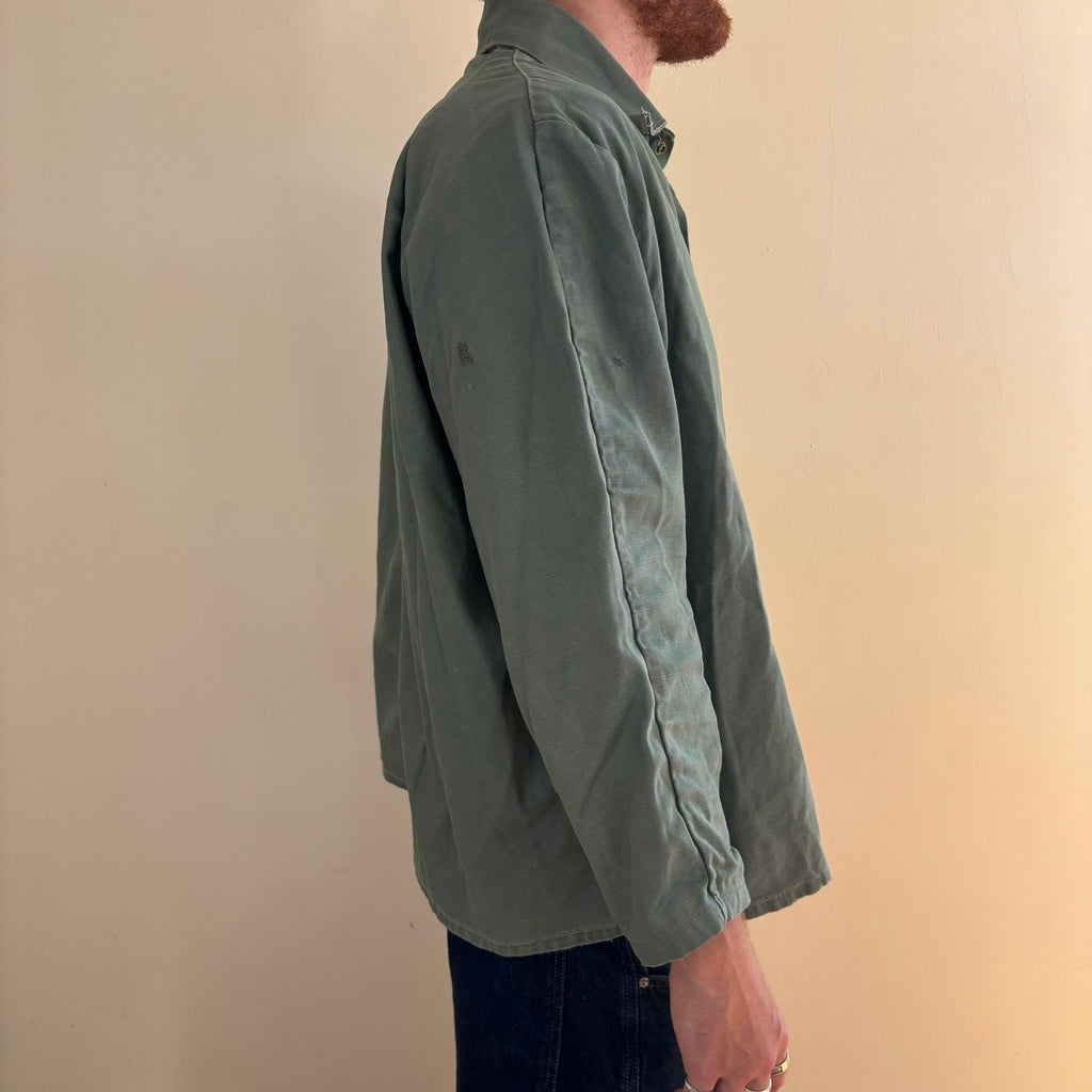 Vintage green cotton work jacket with snap front and stencilled "McLOUTH" on back.