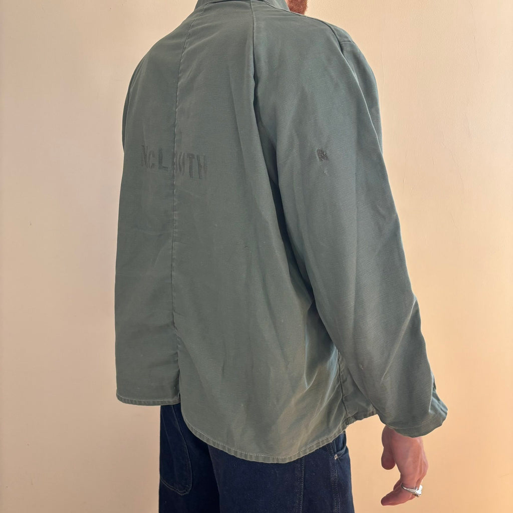 Vintage green cotton work jacket with snap front and stencilled "McLOUTH" on back.