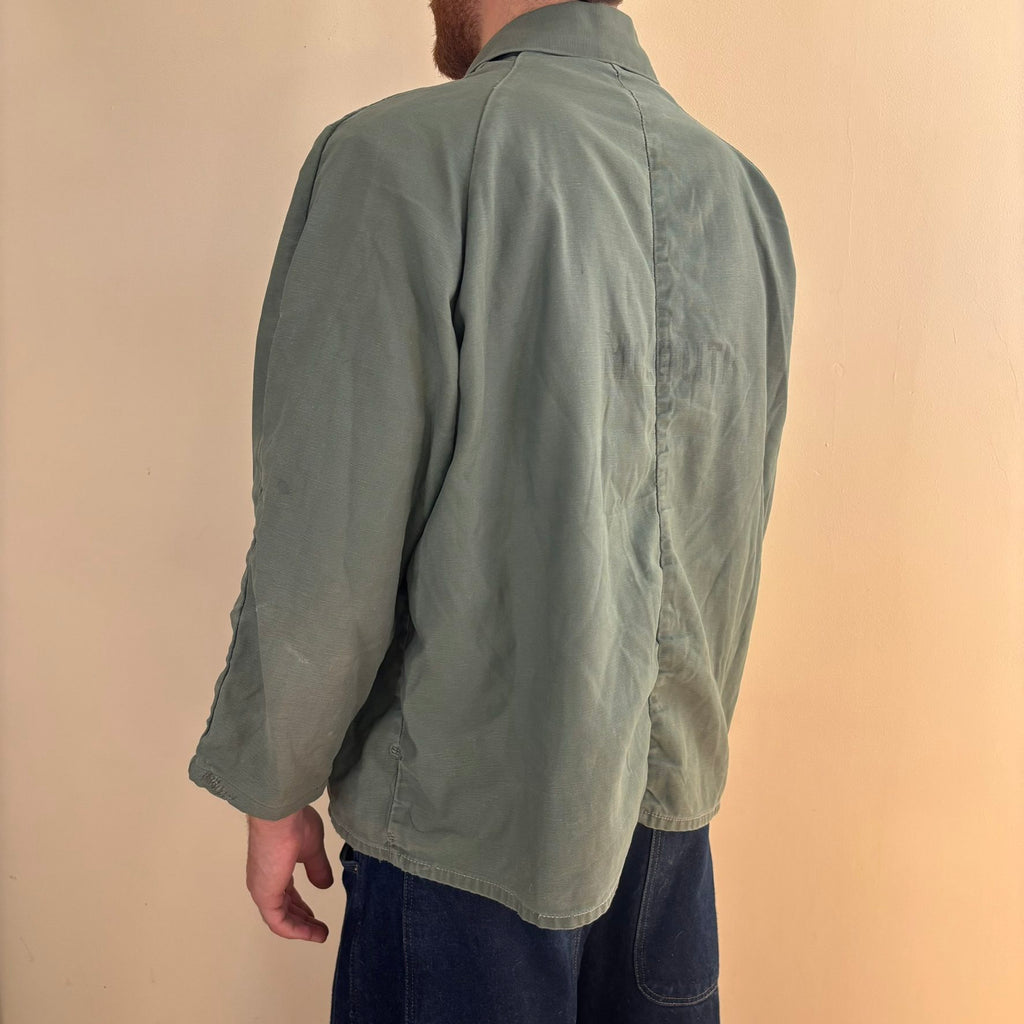Vintage green cotton work jacket with snap front and stencilled "McLOUTH" on back.