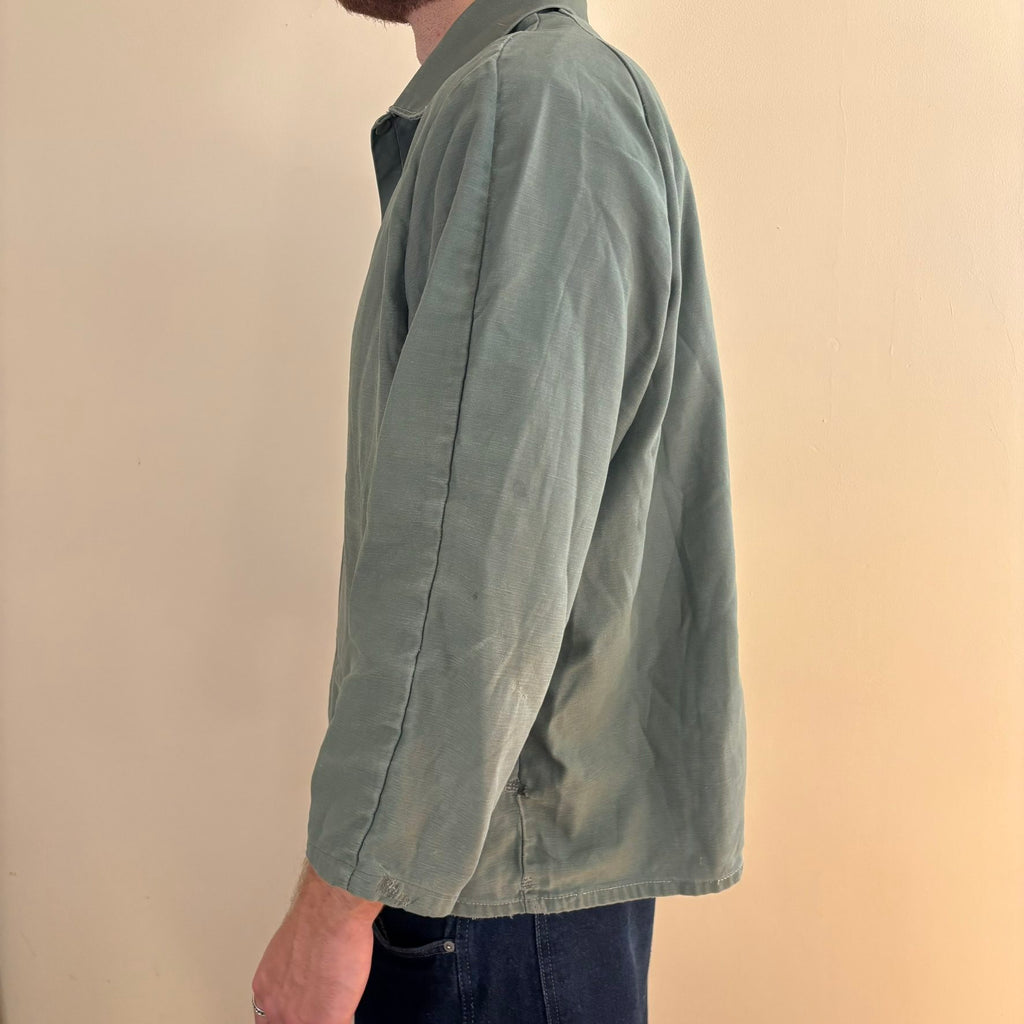 Vintage green cotton work jacket with snap front and stencilled "McLOUTH" on back.